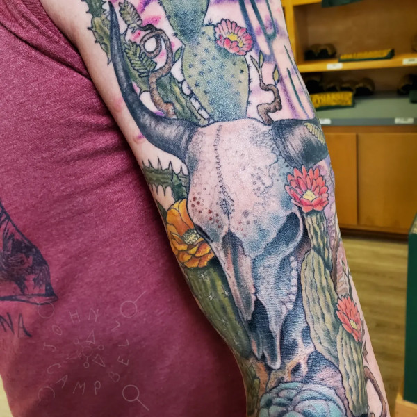 Cattle skull desert with cactus in flower full color sleeve tattoo - close up view. Book a custom tattoo with John at Sacred Mandala Studio - Durham, NC.